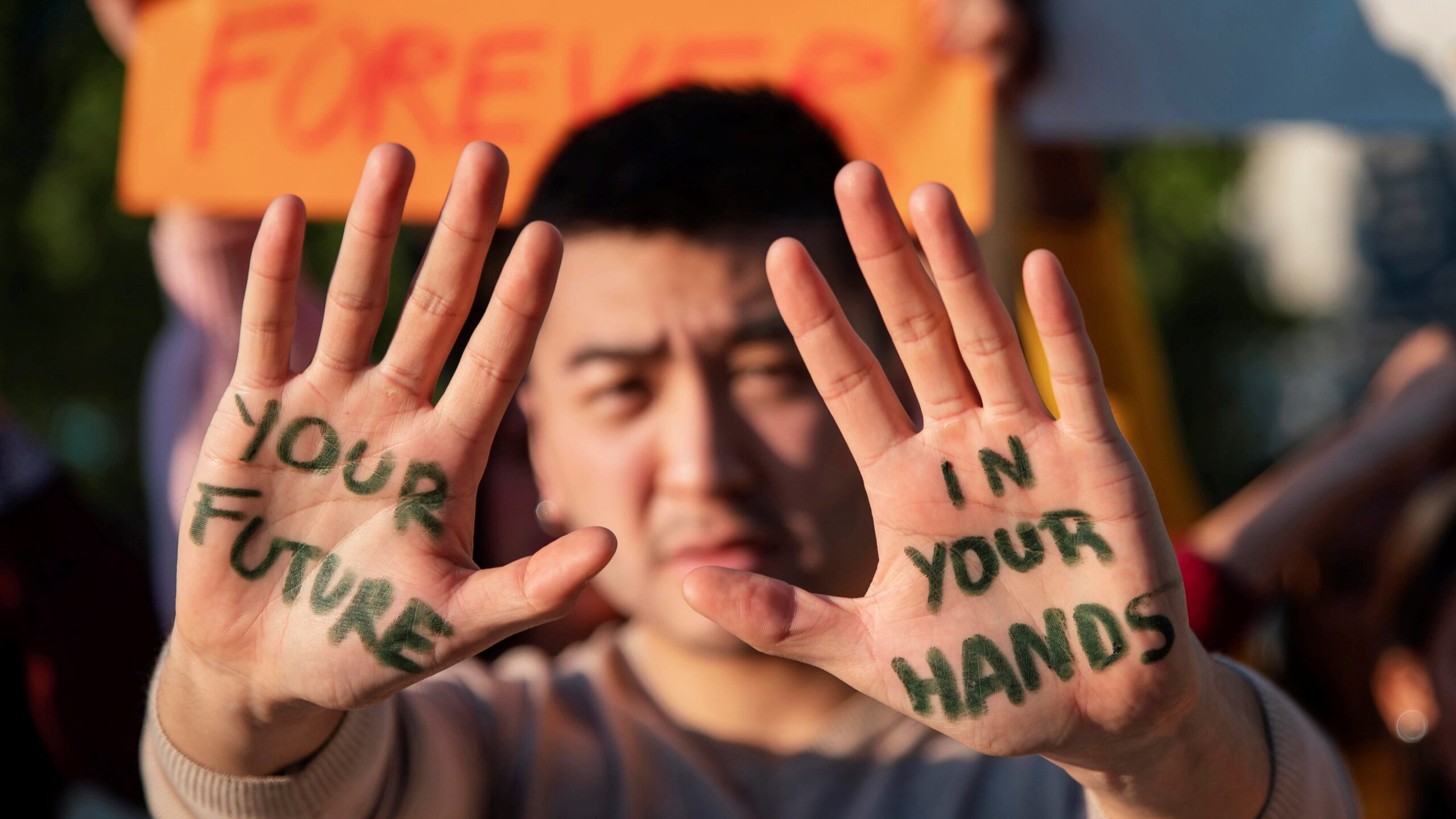 a photo of a man holding up his hands